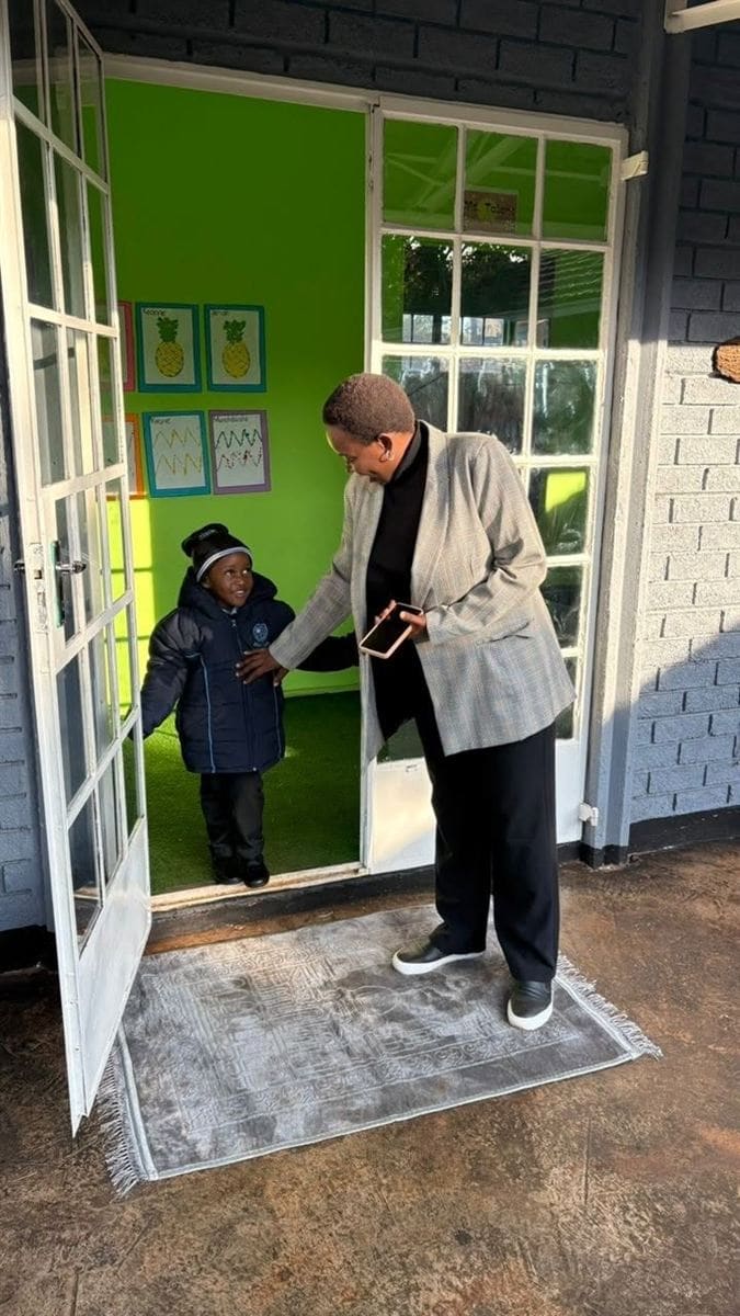 A teacher welcoming a learner to class